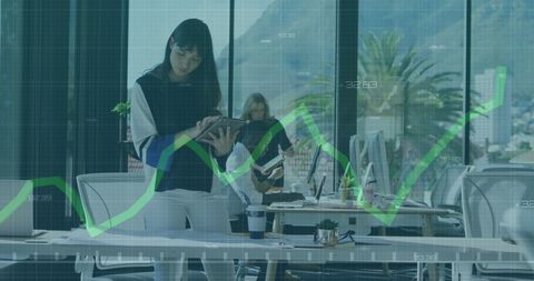 Businesswoman analyzing data with digital technology in modern office