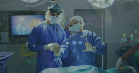 Diverse Medical Team Analyzing Digital Data in Surgery Room