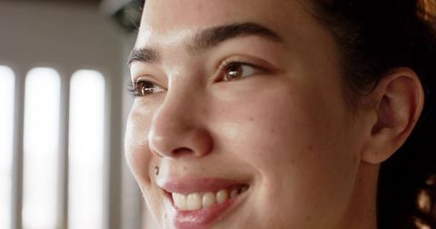 Woman smiling gently with natural beauty and light elegance