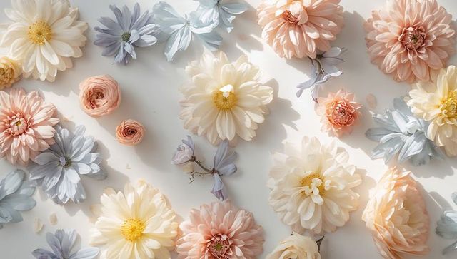 Pastel floral flatlay featuring cream dahlias, peach ranunculus, and lavender daisies