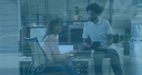 Colleagues Collaborating in Modern Open-Plan Office Space with Technology