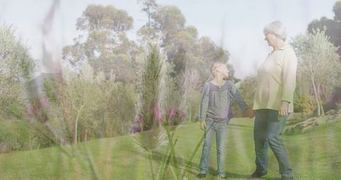 Grandmother and Granddaughter Walking Through Dreamy Garden - Download Free Stock Images Pikwizard.com