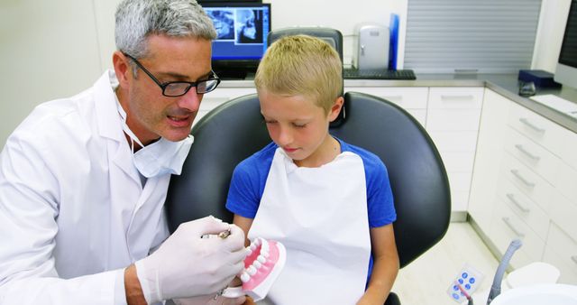 Dentist Explaining Dental Procedure to Child in Clinic - Download Free Stock Images Pikwizard.com