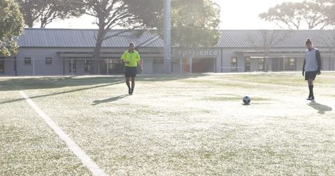 Soccer Player Preparing to Kick Ball on Sunny Field