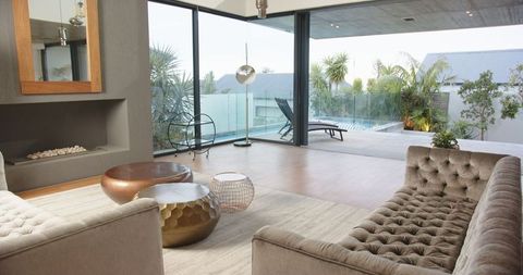 Modern Luxury Living Room with Poolside View and Velvet Seating