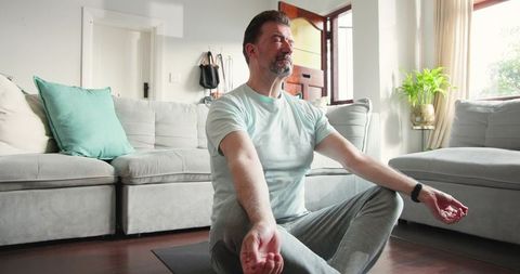 Mature Man Practicing Meditation at Home for Relaxation and Wellness