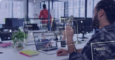 Bearded Developer Working on Laptop with Augmented Data Overlays in Open Office