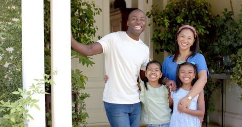 Happy Family of Four Bonding Outdoors on a Sunny Day