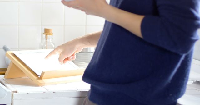 Person Using Digital Tablet for Cooking Instructions in Kitchen - Download Free Stock Images Pikwizard.com