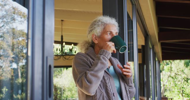 Senior woman enjoying coffee on balcony on beautiful sunny day - Download Free Stock Images Pikwizard.com