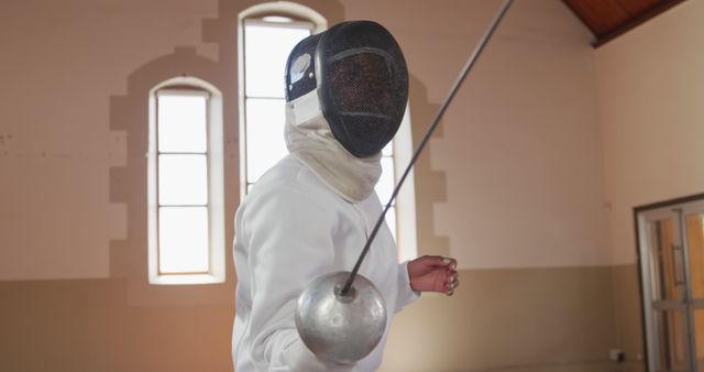 Fencer Ready and Holding Epee in Training Hall - Download Free Stock Images Pikwizard.com