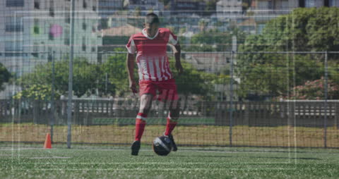 Biracial Footballer Training on Sunny Field with Data Overlay