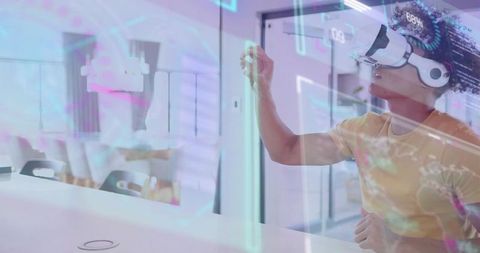Young man wearing vr headset interacting with holographic interface in modern minimalist office