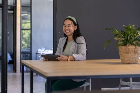 Confident Businesswoman Using Tablet in Modern Conference Room