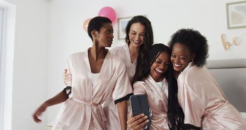 Joyful Women Celebrating Friendship in Luxurious Silk Robes