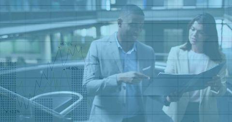 Professionals Collaborating on Financial Analytics by Glass Railing