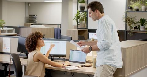 Team Collaborating in Modern Open Plan Office with Technology