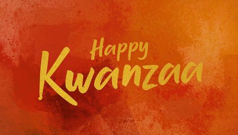 Celebrating kwanzaa with gold brush calligraphy on warm red orange grunge backdrop