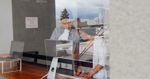 Business Meeting Through Office Window Reflection