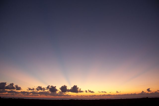 Beautiful sunrise captured at Cape Canaveral, Florida with vibrant sky and clouds. This photo can be used for travel brochures, nature photography collections, and publications related to space missions or atmospheric studies.
