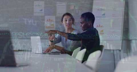 Diverse Female Team Analyzing Financial Data in Office