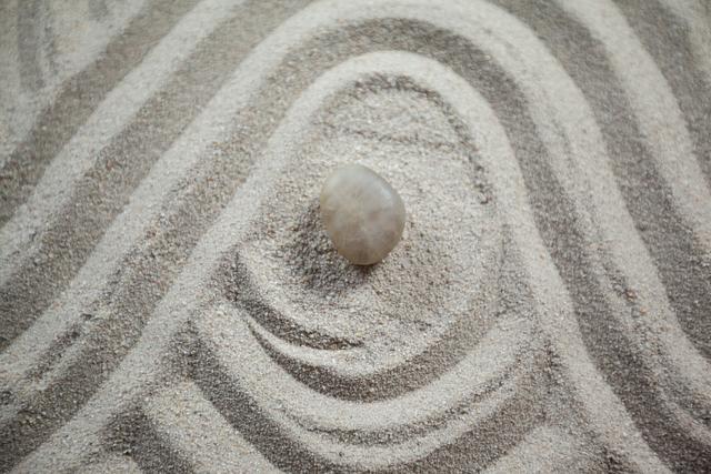 Zen garden with raked sand and stone - Download Free Stock Photos Pikwizard.com