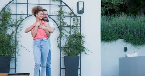 Couple Embracing Outdoors Happy Together in Garden