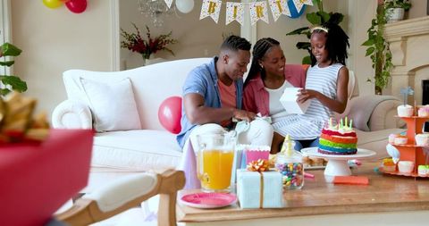 Happy Family Celebrating Birthday with Cake and Gifts