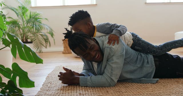 Playful AfAm Father and Son Bonding at Home - Download Free Stock Images Pikwizard.com