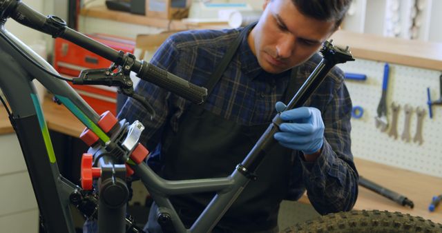 Dedicated Mechanic Fixing Bicycle in Workshop - Download Free Stock Images Pikwizard.com