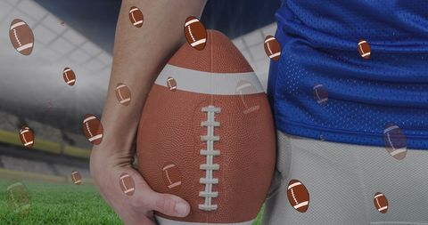 Rugby player holding ball at energetic stadium background