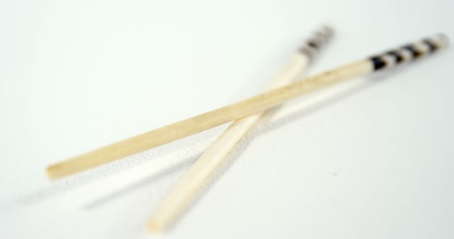 Close-up of Wooden Chopsticks on White Background - Download Free Stock Images Pikwizard.com