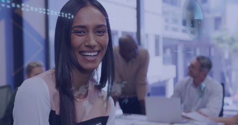 Smiling woman leading team discussion in bright conference room
