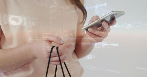 Woman holding phone and shopping bag cords tapping mobile with holographic ui overlay