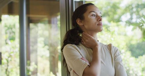 Peaceful Woman Gazing Through Sunny Window