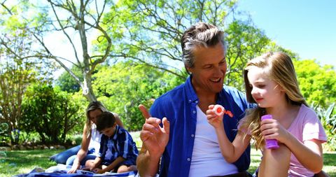 Family Fun with Bubbles in Sunlit Park
