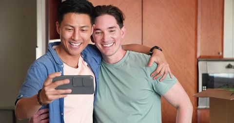 Happy Diverse Male Couple Smiling Together at Home