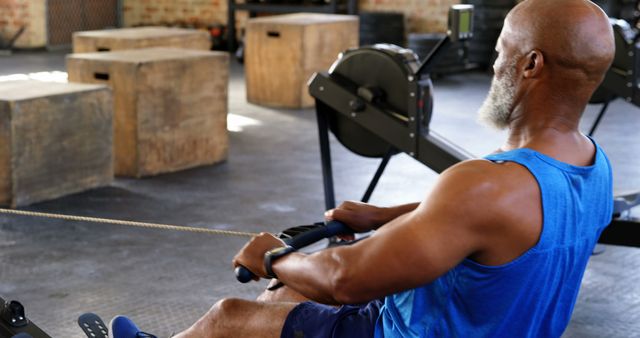 Senior Man Exercising on Rowing Machine in Gym - Download Free Stock Images Pikwizard.com