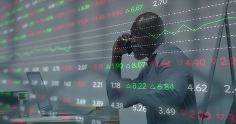 Business professional analyzing stock market data while on call