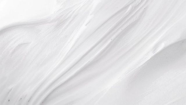Minimal off-white texture featuring flowing diagonal striations and fine speckle grain