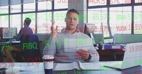 Businessman Analyzing Data in Modern Office with Digital Chart Overlay