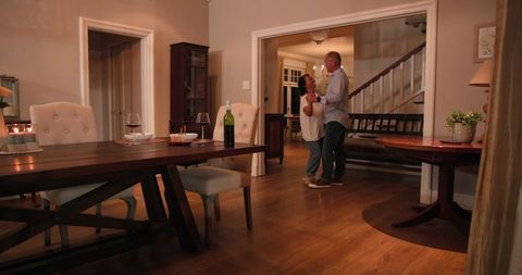 Senior Couple Dancing Joyfully at Home, Celebrating Together