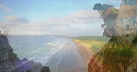 Backpacker on dramatic cliff overlooking scenic coastline