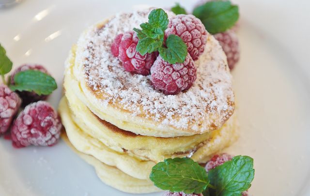 Fluffy Pancakes With Powdered Sugar and Frozen Raspberries - Download Free Stock Photos Pikwizard.com