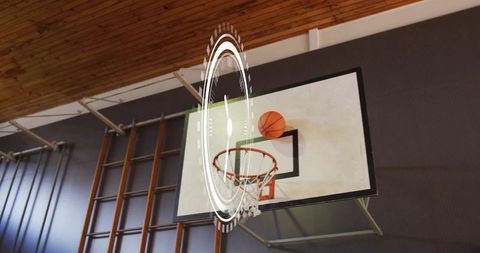 Basketball ball perching on rim with augmented reality hud in indoor gymnasium