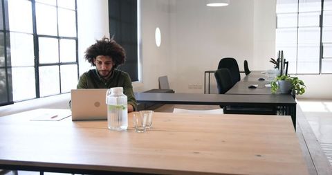 Man working on laptop in modern minimalist office space
