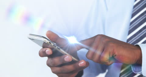 Businessman Interacting with Smartphone and Digital Light Effects