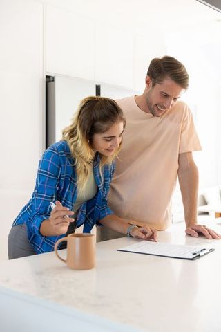 Couple Reviewing Paperwork in Contemporary Kitchen