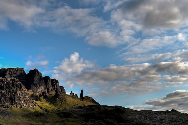 Dramatic Landscape with Rock Formations and Cloudy Sky - Download Free Stock Photos Pikwizard.com