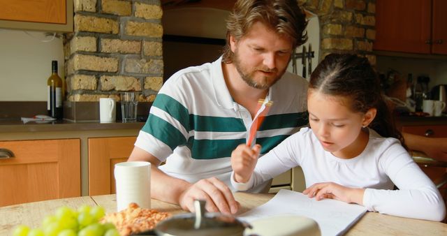 Middle-aged Man Helping Girl with Homework in Cozy Kitchen Setting, Copy Space - Download Free Stock Images Pikwizard.com